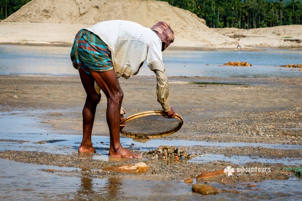 Collecting stone from shallow river in Jaflong