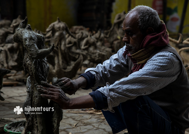 Photo of an artisan making deity in Shakhari Bazar - one of the must places to visit in Dhaka