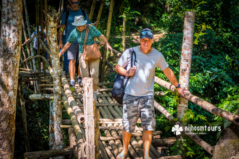 Crossing a bamboo bridge toward a Khasi tribal village