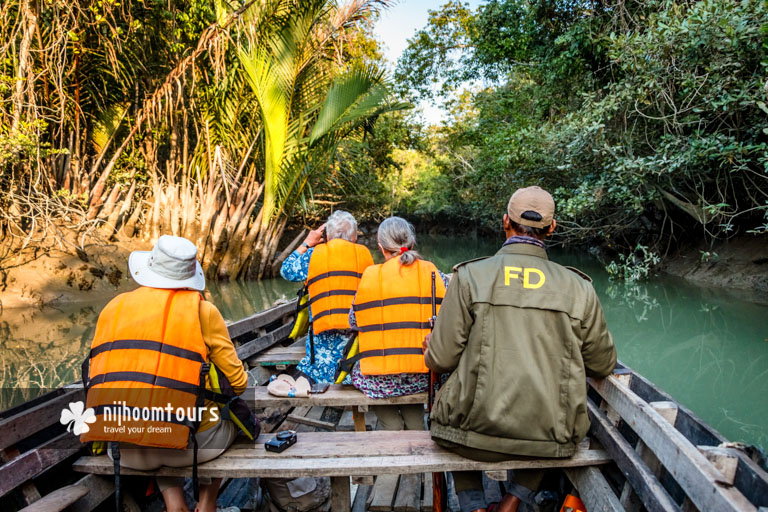 Exploring a channel with a wooden rowing boat with proper safety in searching for wildlife