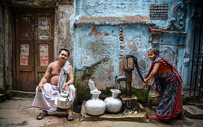 A photo of a woman filling water jars at Old Dhaka in Dhaka (West) Photography Tour